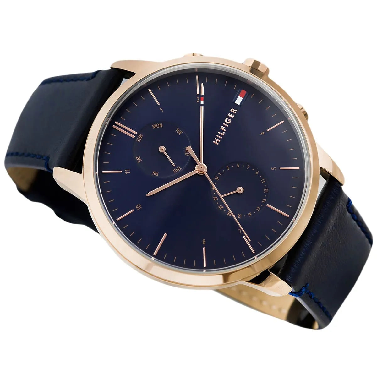Tommy Hilfiger Hunter watch flat lay showing blue dial, rose gold case, and navy leather strap detail