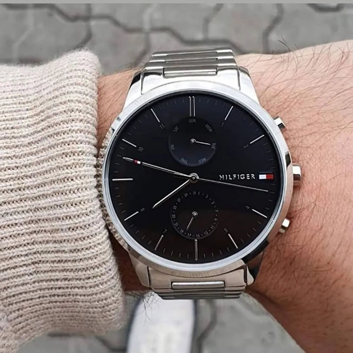 Tommy Hilfiger 1710407 watch worn on wrist showing black dial and silver bracelet fit