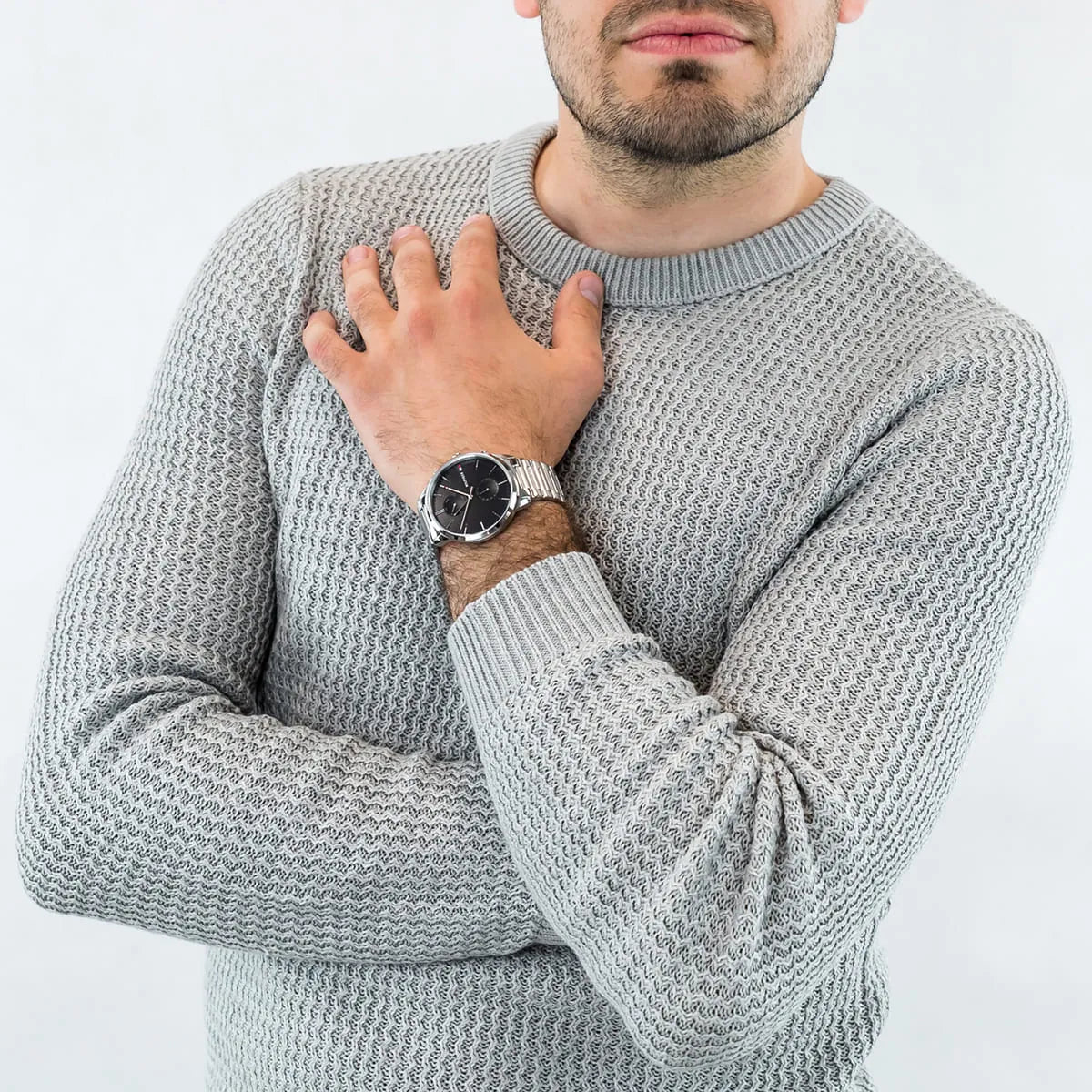 Tommy Hilfiger 1710407 watch on wrist worn with gray sweater, black dial visible