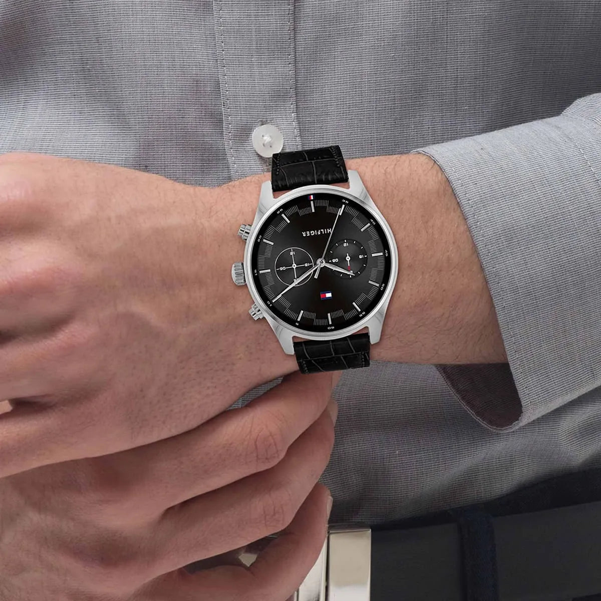 Tommy Hilfiger watch on wrist paired with formal gray shirt cuff