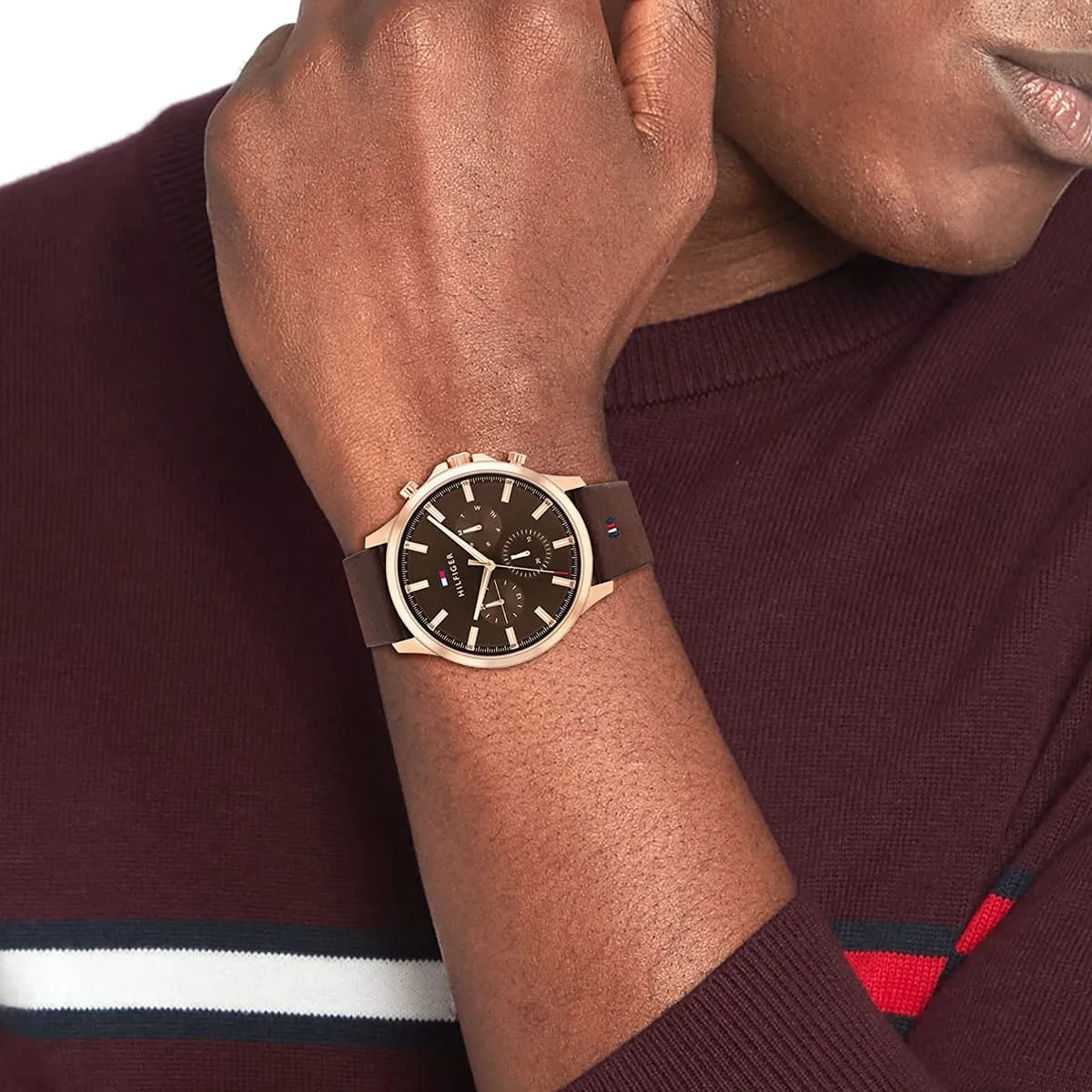 Ryder watch on wrist showing brown dial, rose gold case, and brown leather strap in lifestyle setting