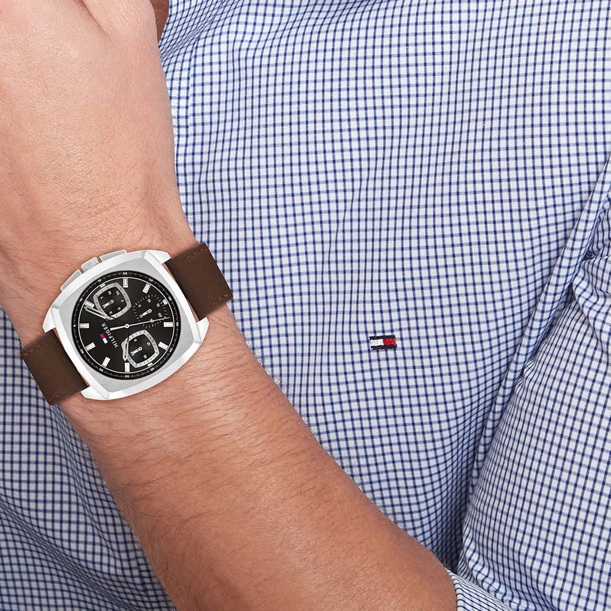 Tommy Hilfiger men's watch worn on wrist with black dial and brown leather strap