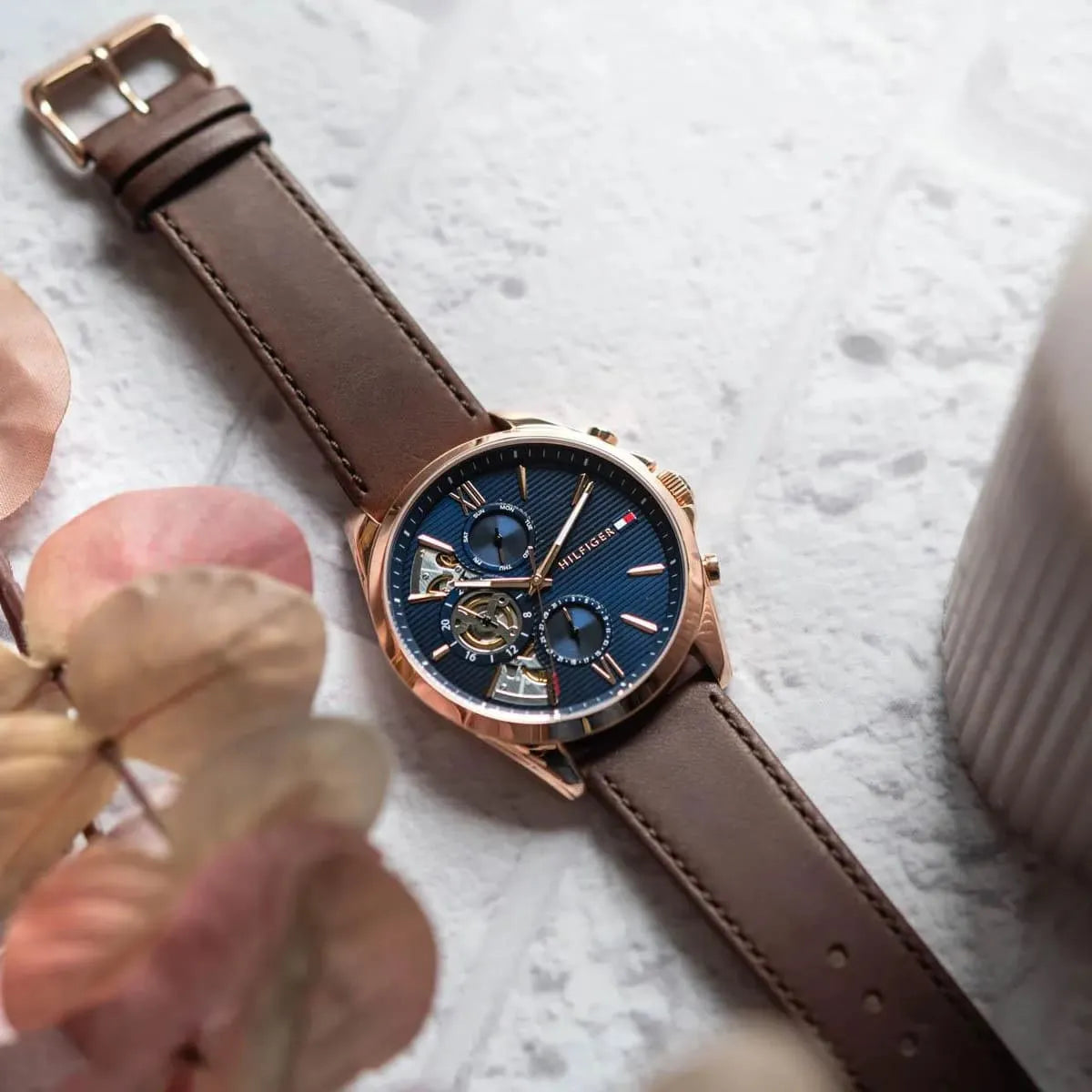 Close-up product image of Tommy Hilfiger Baker watch showing dial detail and leather strap