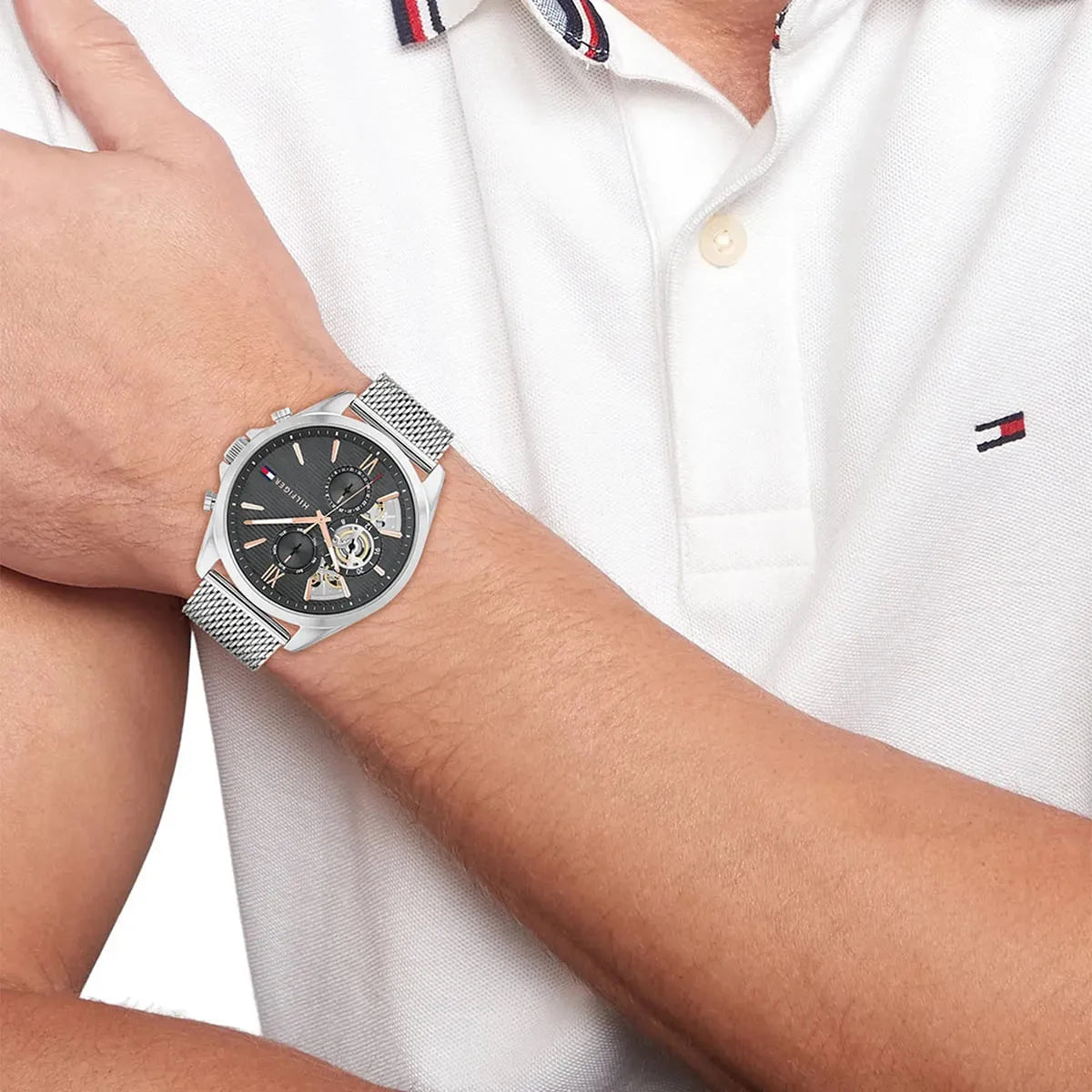 Tommy Hilfiger Baker watch on wrist with silver mesh strap and black dial