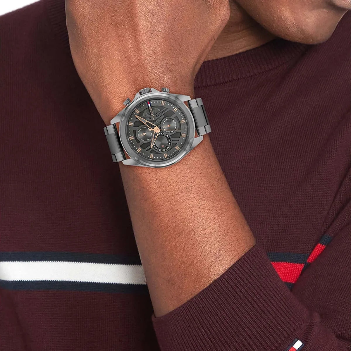 Tommy Hilfiger gray chronograph watch worn on wrist with stainless steel bracelet
