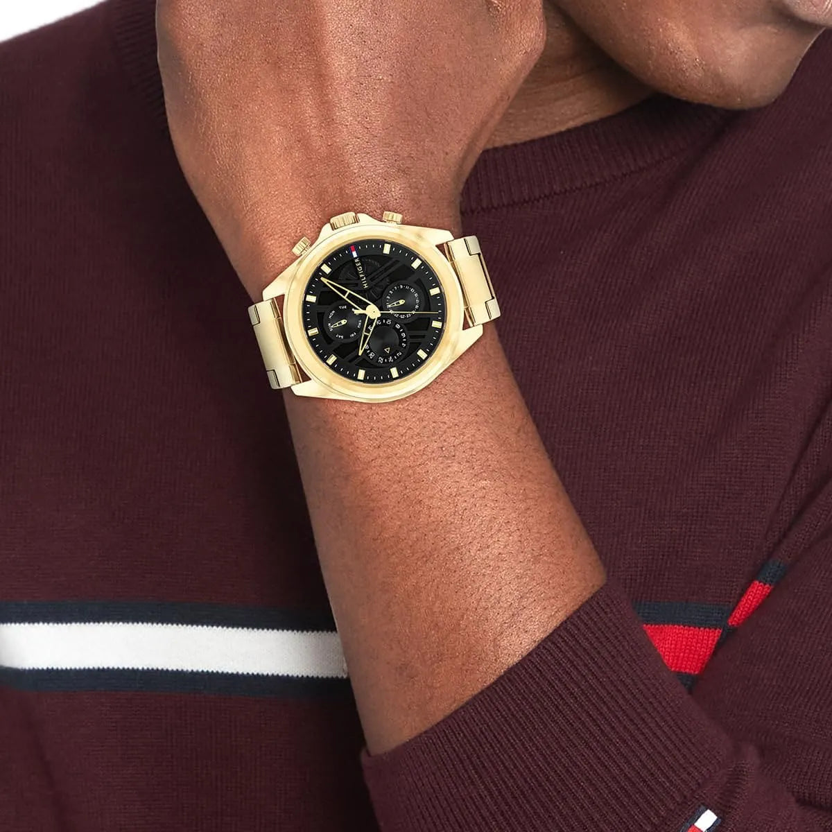Tommy Hilfiger JAX gold chronograph watch worn on wrist with black dial visible