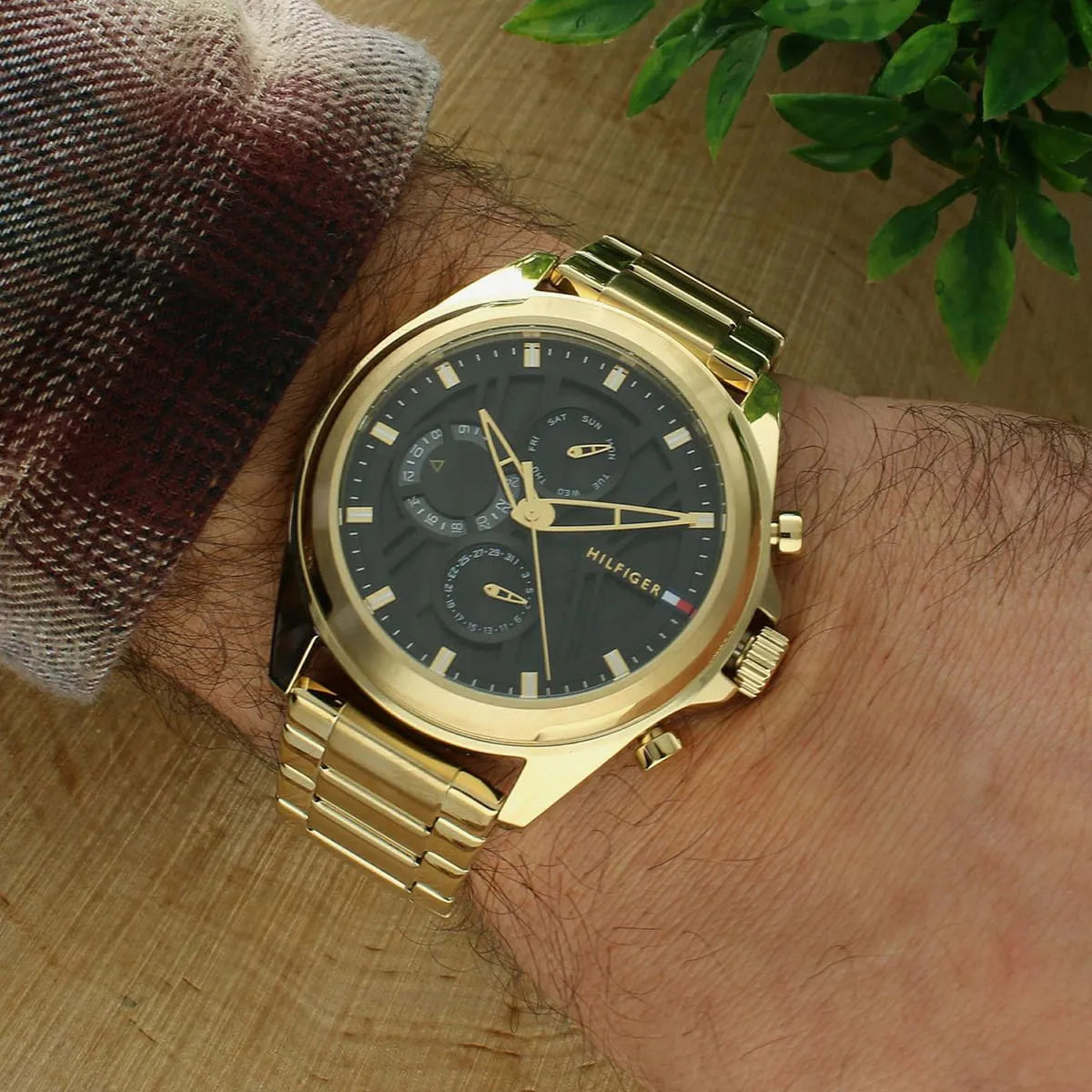 Tommy Hilfiger JAX gold watch on wrist showing chronograph dial and gold bracelet fit