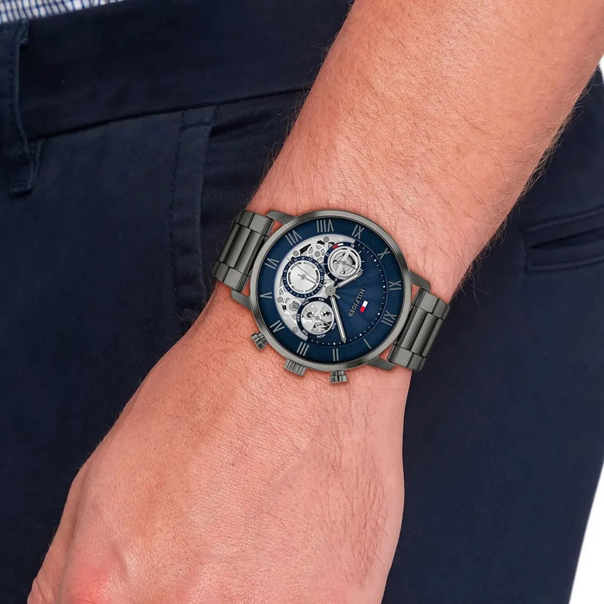 Tommy Hilfiger Legend men's chronograph watch worn on wrist with navy dial and gunmetal bracelet