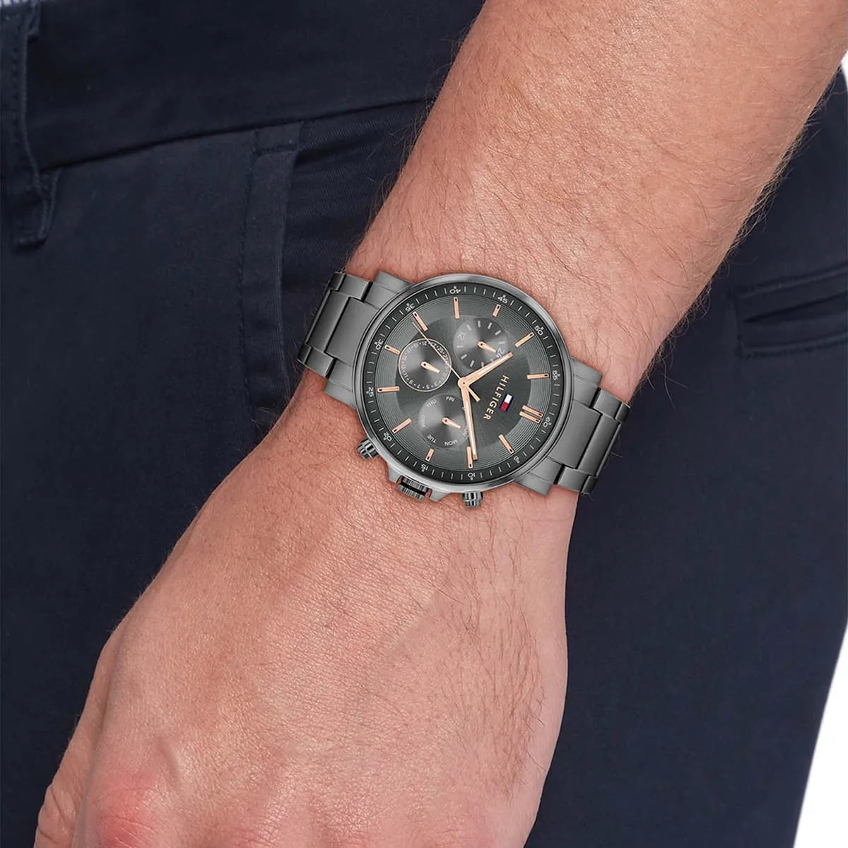 Tommy Hilfiger chronograph watch worn on wrist showing gray dial and stainless steel bracelet