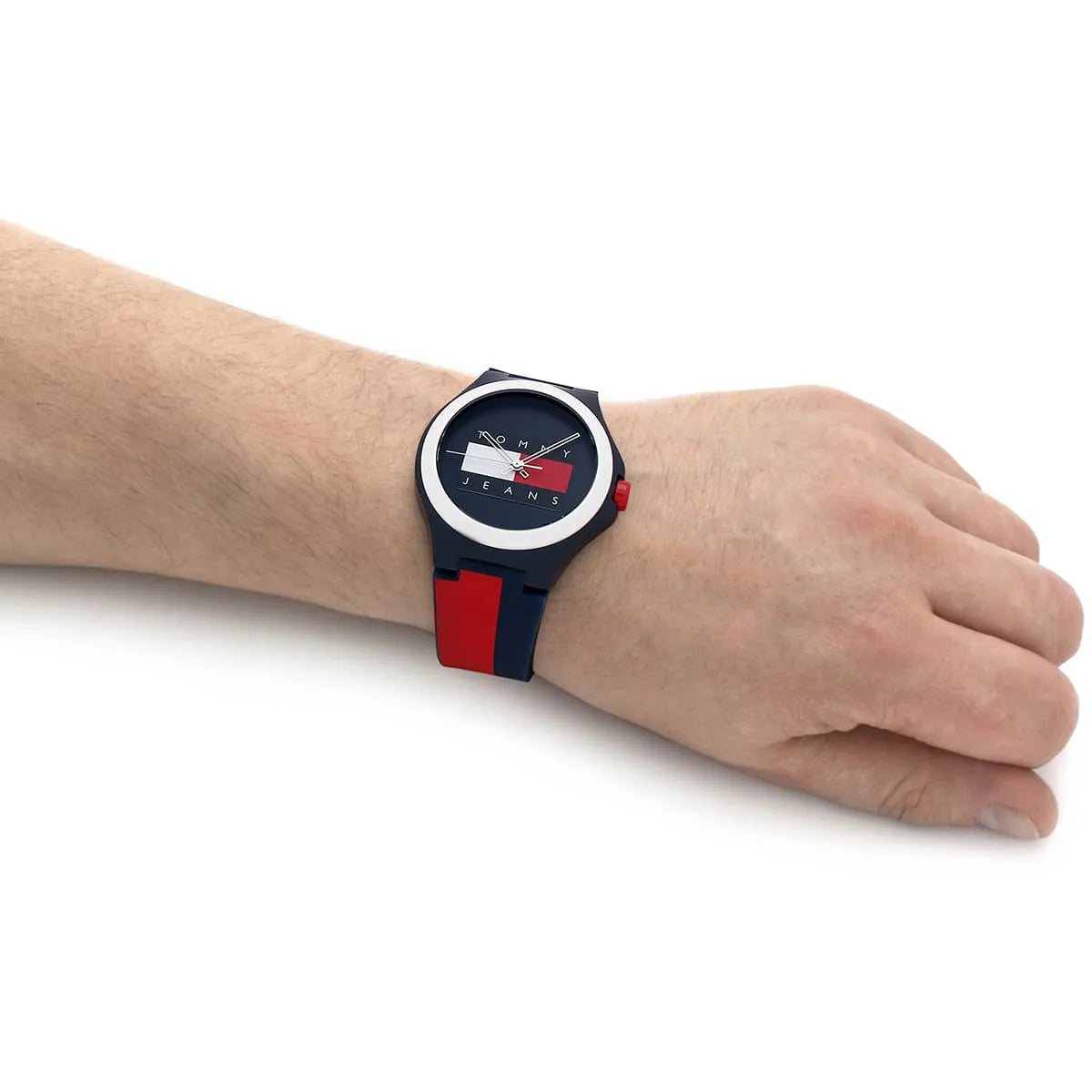 Tommy Hilfiger watch worn on wrist showing navy and red strap