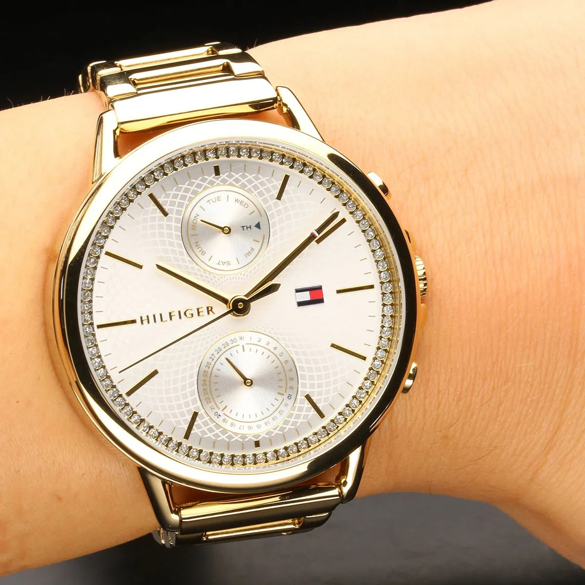 Tommy Hilfiger women's watch on wrist showing silver dial with gold accents