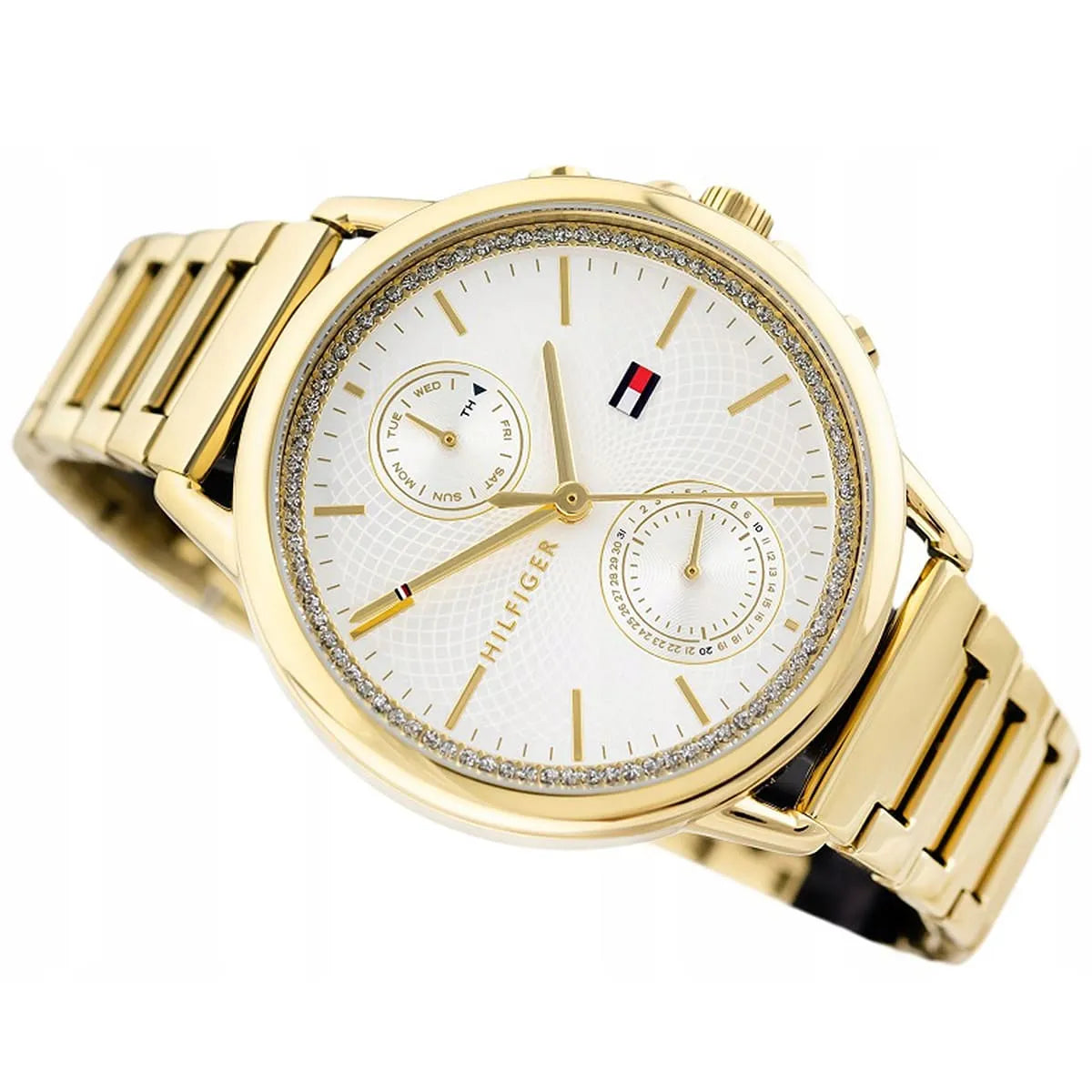 Side angle of Tommy Hilfiger women's watch with gold strap and silver dial visible