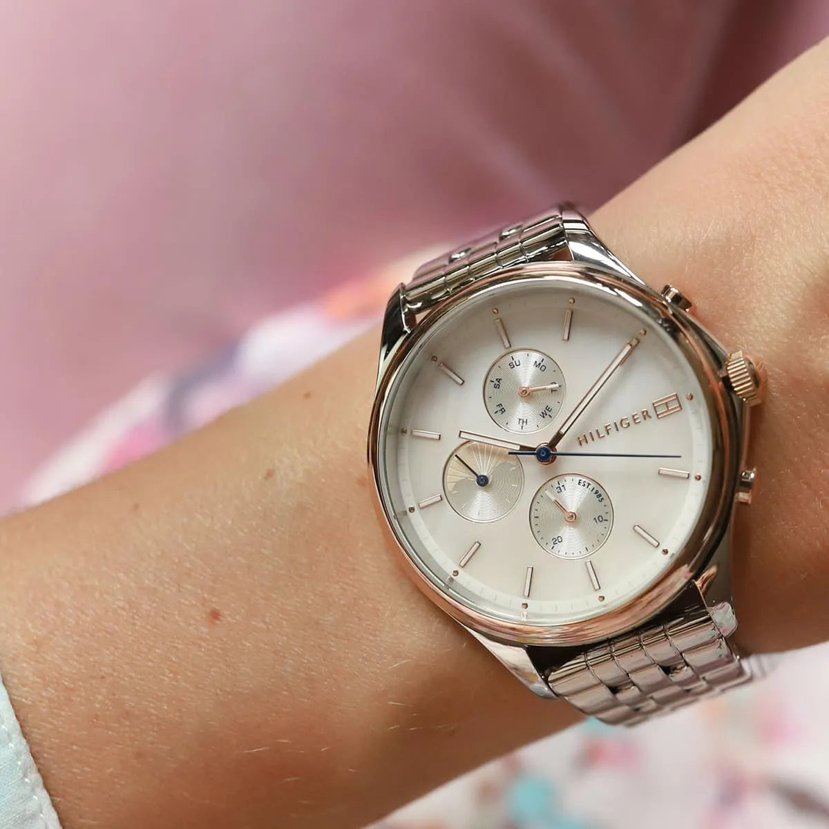 Tommy Hilfiger Whitney chronograph watch worn on wrist showing white dial and metal strap