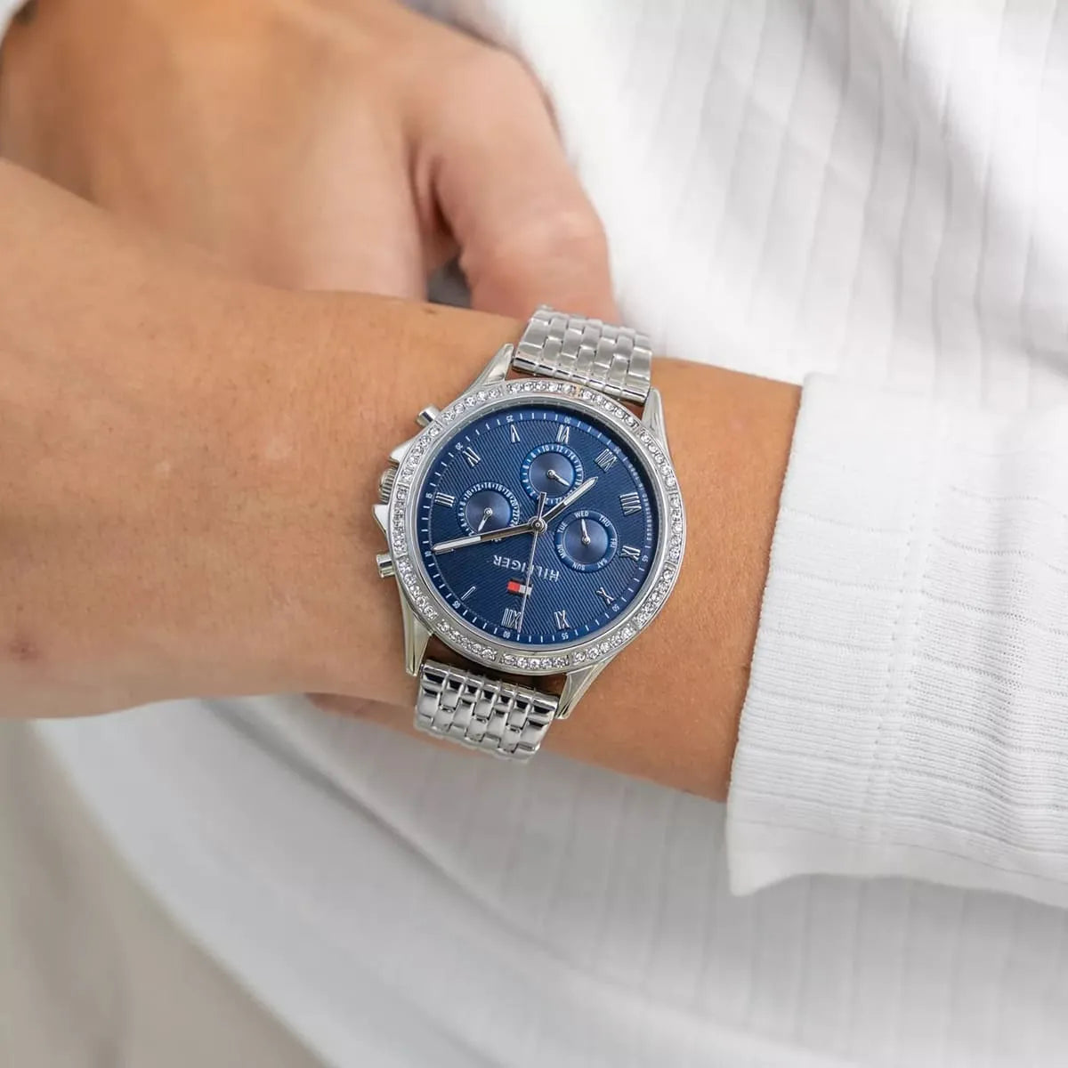 Tommy Hilfiger women's watch on wrist showing blue dial and multi-function chronograph subdials