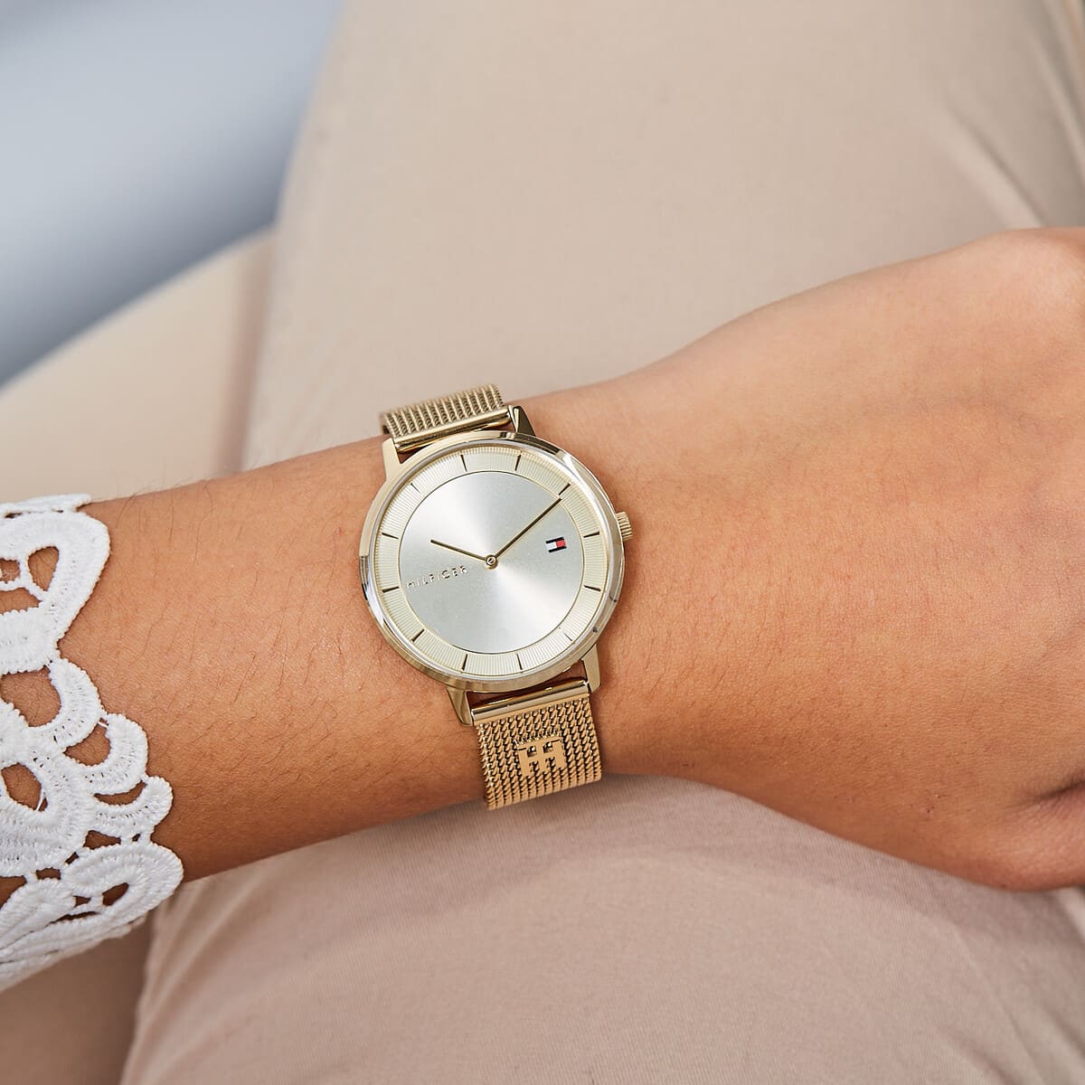 Tommy Hilfiger 1782286 gold watch worn on wrist showing cream dial and mesh bracelet