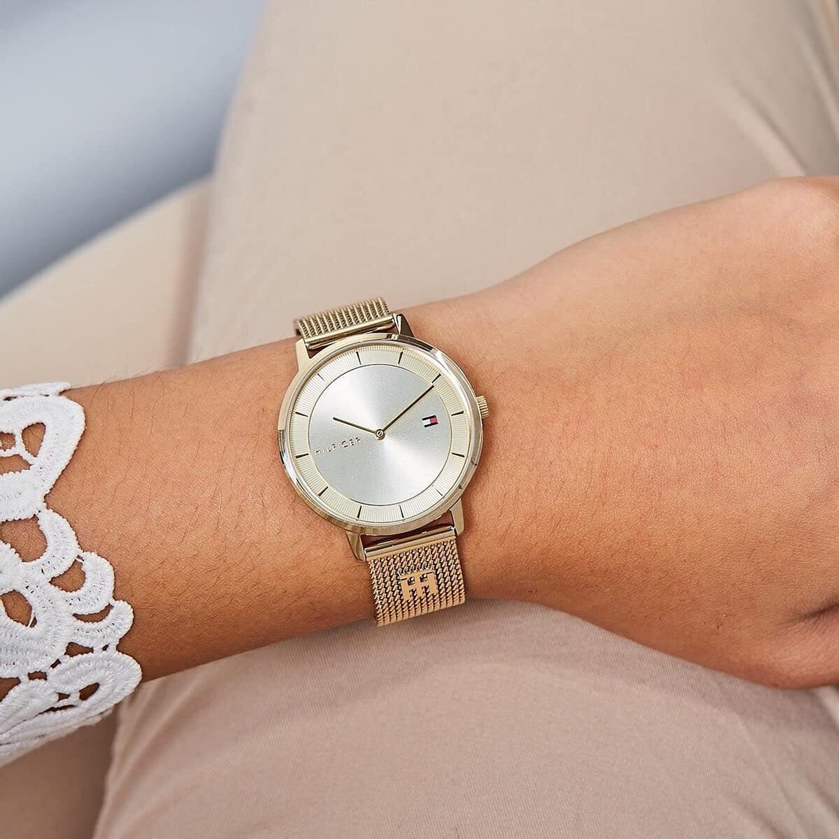 Tommy Hilfiger women's watch with light taupe dial and mesh strap worn on wrist