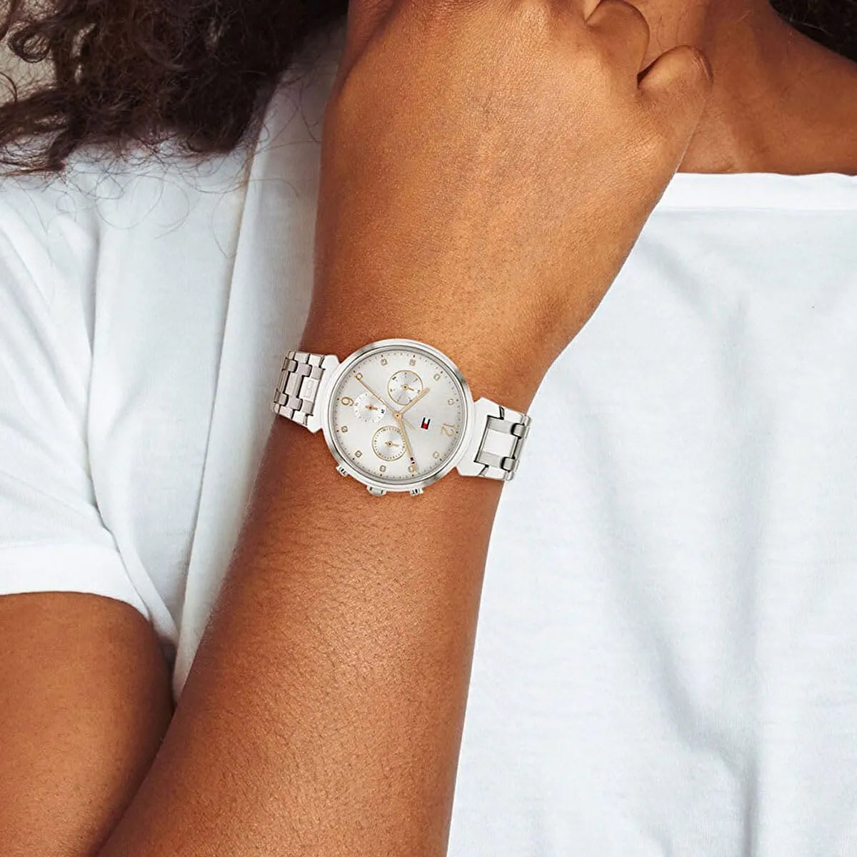 Tommy Hilfiger Ivy women's watch worn on wrist showing silver stainless steel strap and gray dial