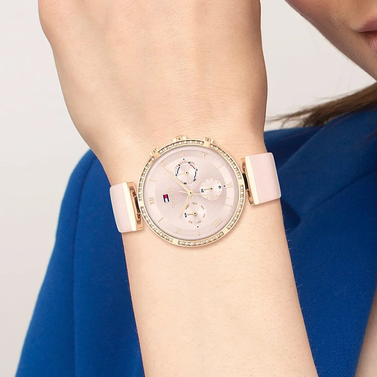 Tommy Hilfiger Luna watch worn on wrist showing rosegold case, pink dial, and diamond-set bezel
