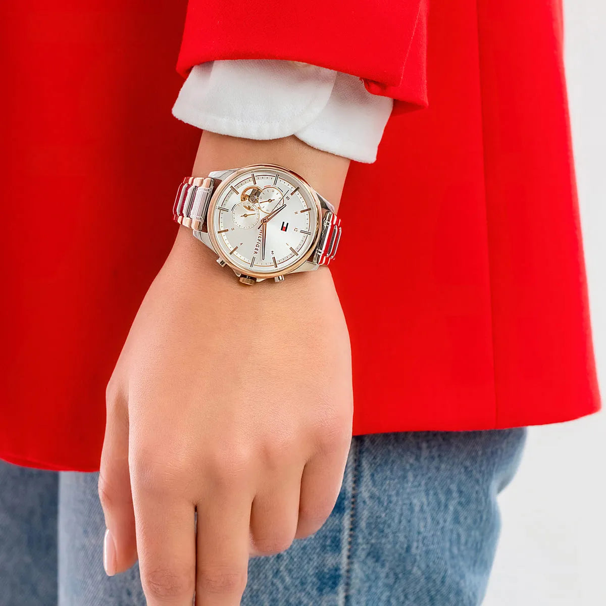 Tommy Hilfiger Quinn watch worn on wrist styled with red dress and accessories