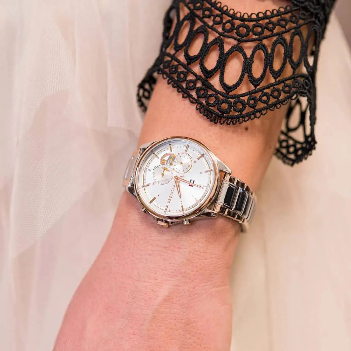 Tommy Hilfiger Quinn women's watch on wrist with lace sleeve detail