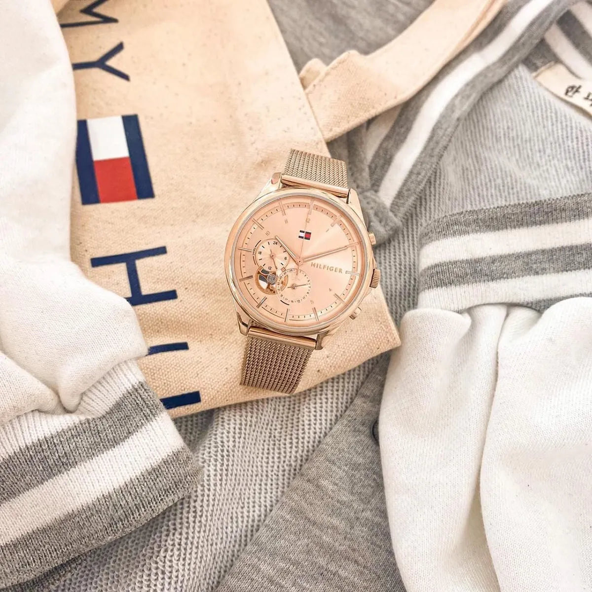 Rose gold Tommy Hilfiger Quinn watch displayed on Tommy Hilfiger branded fabric