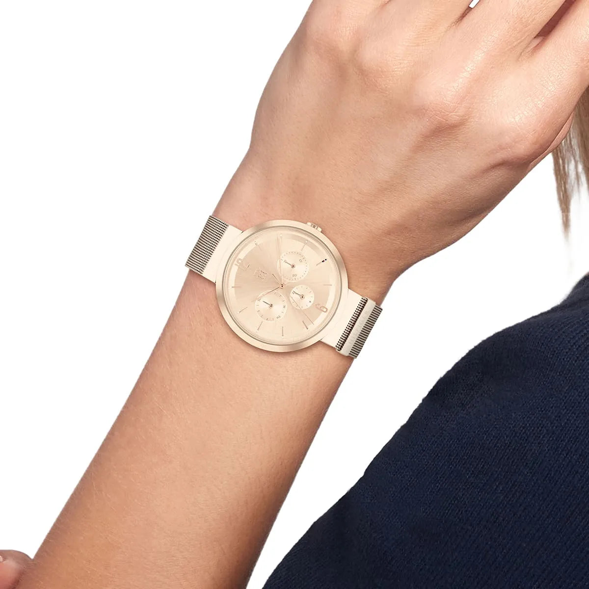 Tommy Hilfiger Lidia watch styled on wrist with rose gold dial and mesh strap