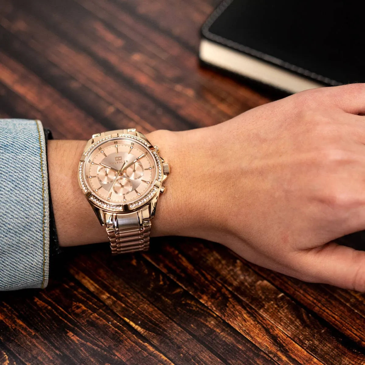 Tommy Hilfiger rose gold chronograph watch worn on wrist with blue fabric visible