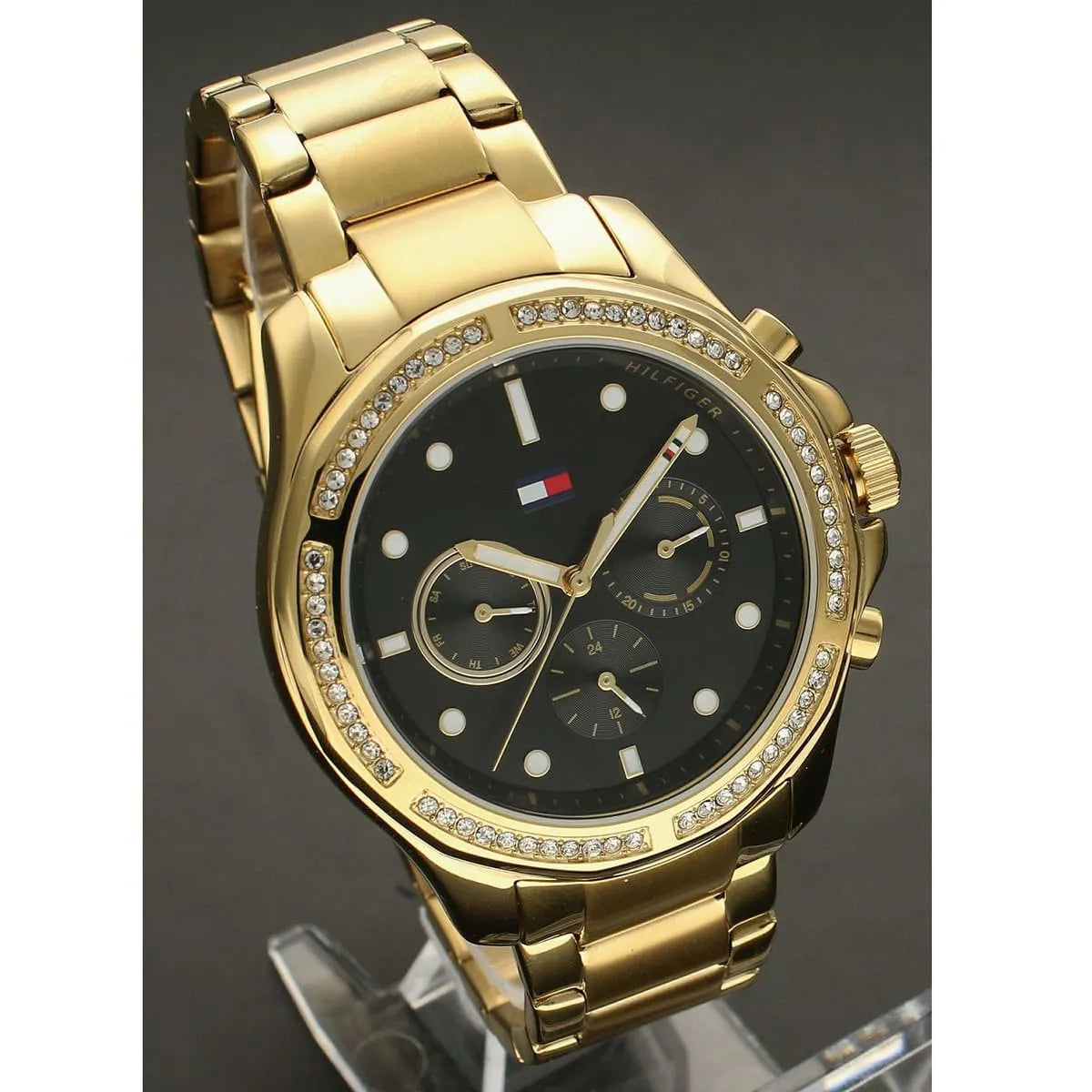 Angled view of Tommy Hilfiger Libby women's watch showing chronograph subdials and gold bracelet