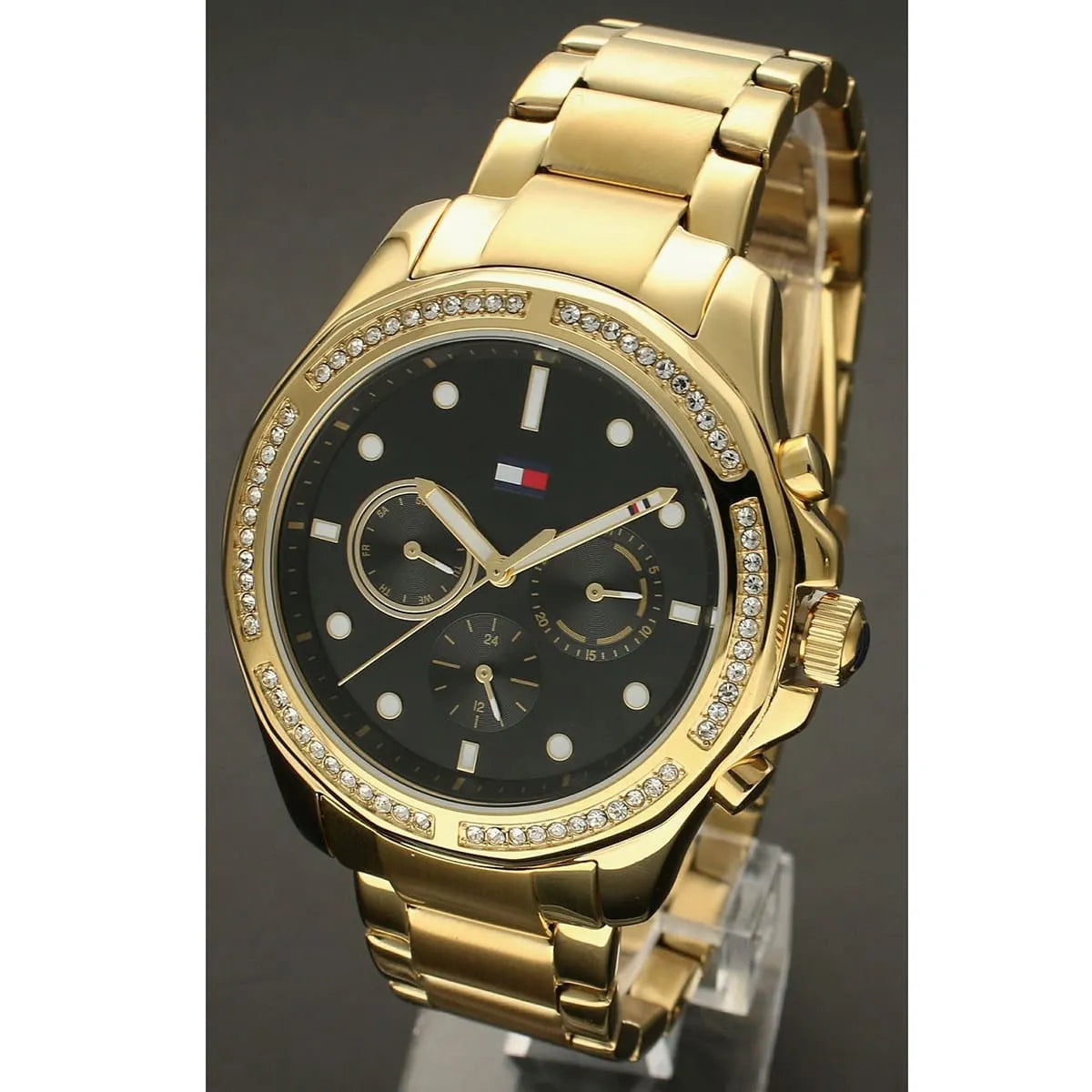 Front view of Tommy Hilfiger Libby women's watch with black dial, crystal bezel, and gold case