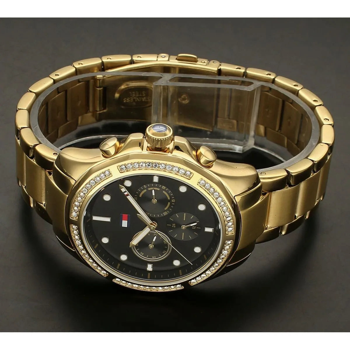 Top-down view of Tommy Hilfiger Libby women's chronograph watch with gold bracelet and black dial