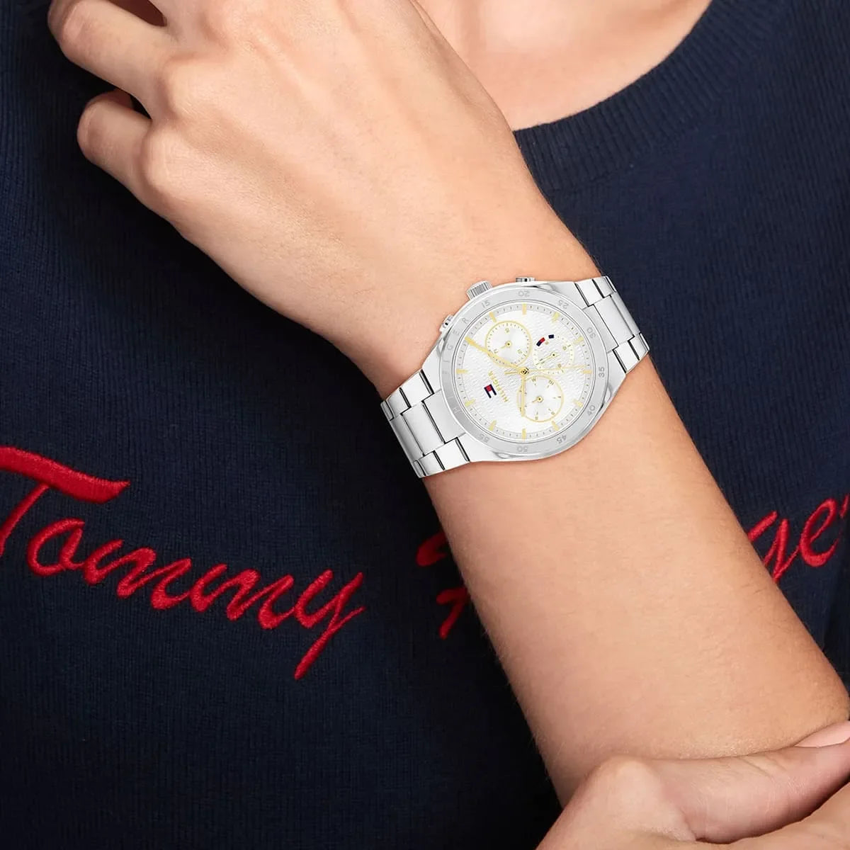 Tommy Hilfiger Libby women's watch worn on wrist with navy sweater