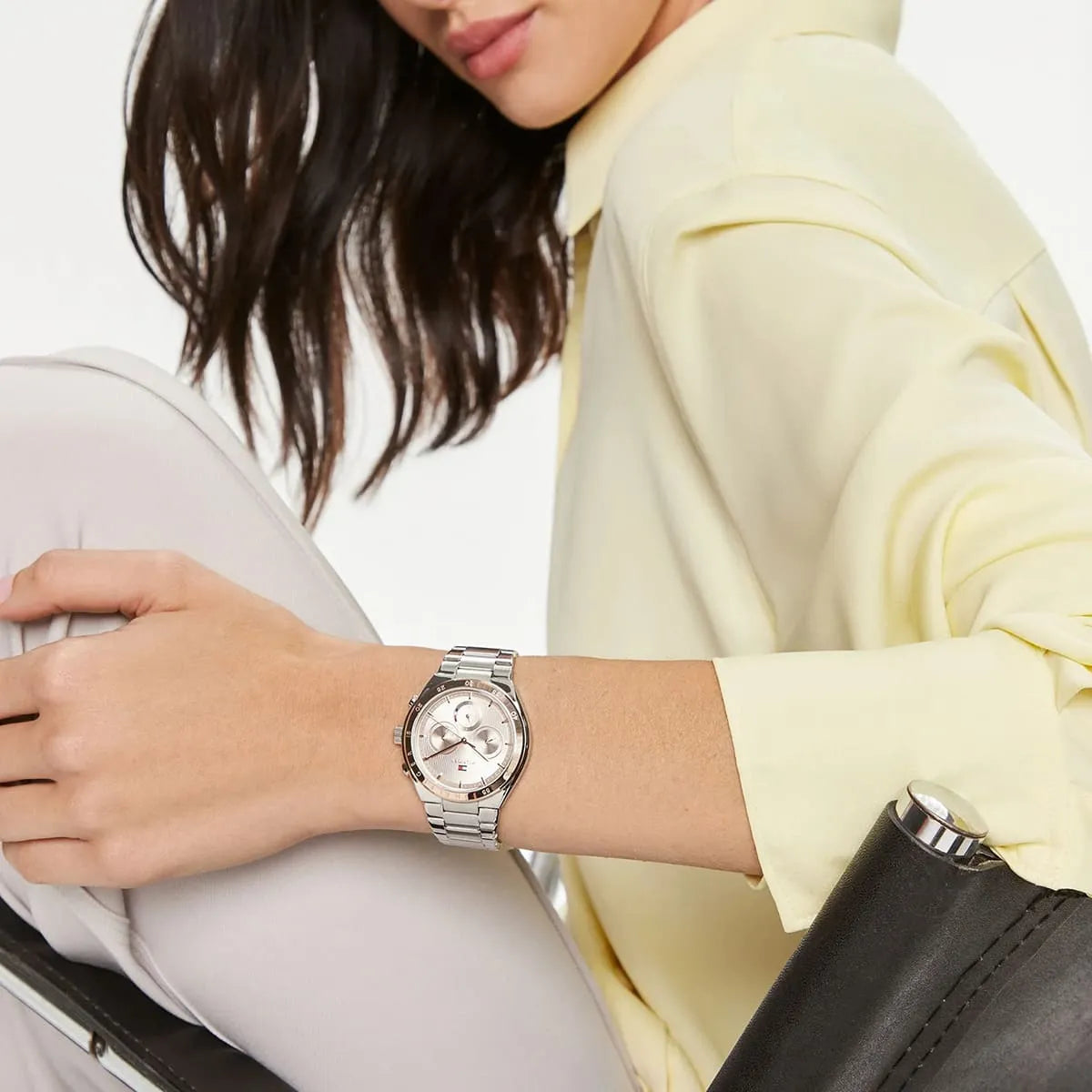 Tommy Hilfiger women's quartz watch worn on wrist with silver-tone metal bracelet strap