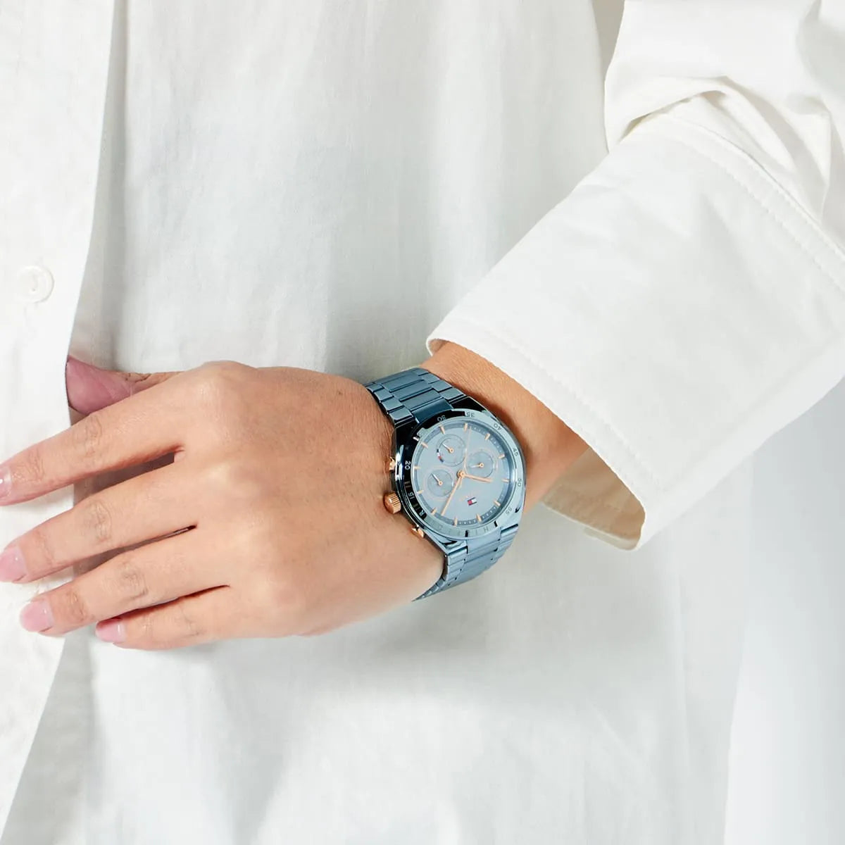 Tommy Hilfiger Carrie blue watch worn on wrist with white sleeve