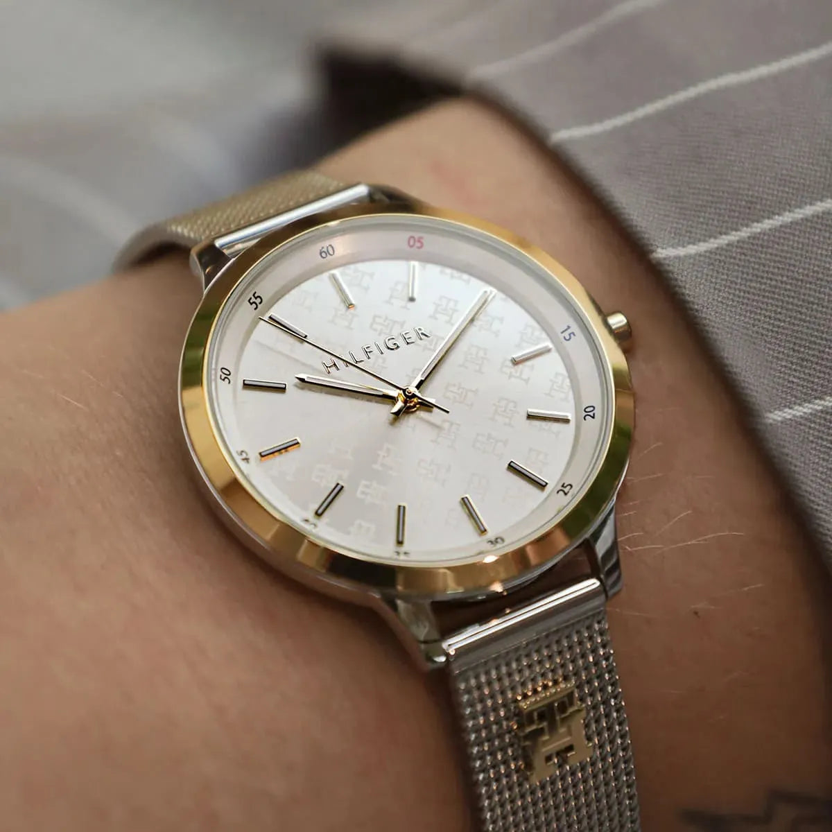 Tommy Hilfiger Iris watch on wrist displaying three-hand dial and gold details