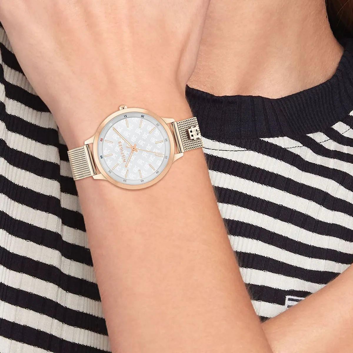 Tommy Hilfiger women's watch worn on wrist with rose gold mesh strap