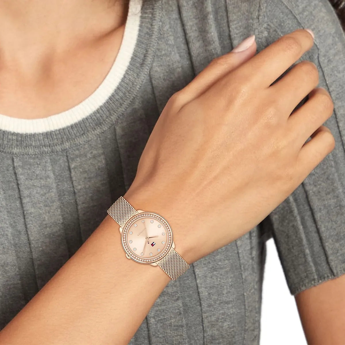 Tommy Hilfiger Demi rose gold women's watch styled on wrist with gray sweater