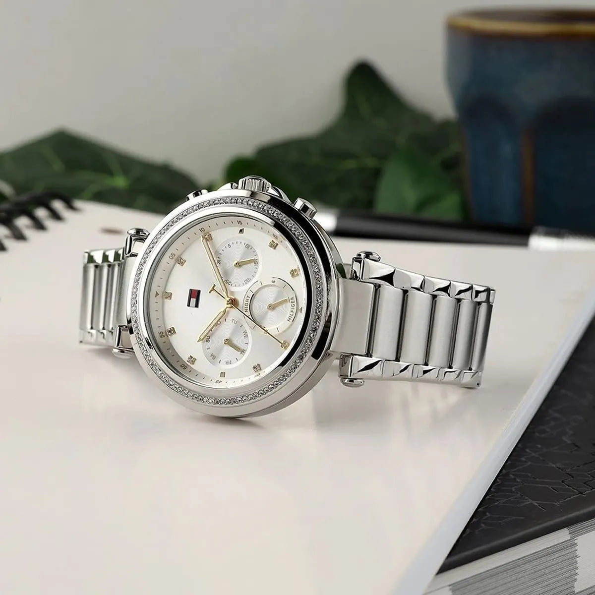 Tommy Hilfiger women's chronograph watch displayed on white surface with stainless steel band