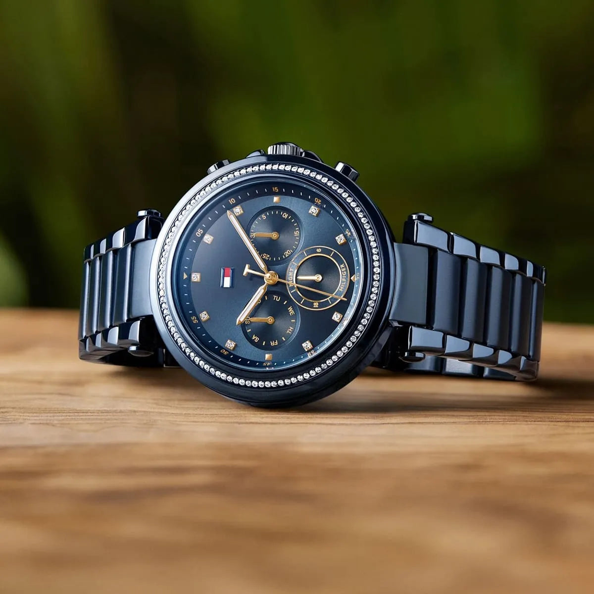 Tommy Hilfiger Emily chronograph watch displayed on wooden surface with navy strap