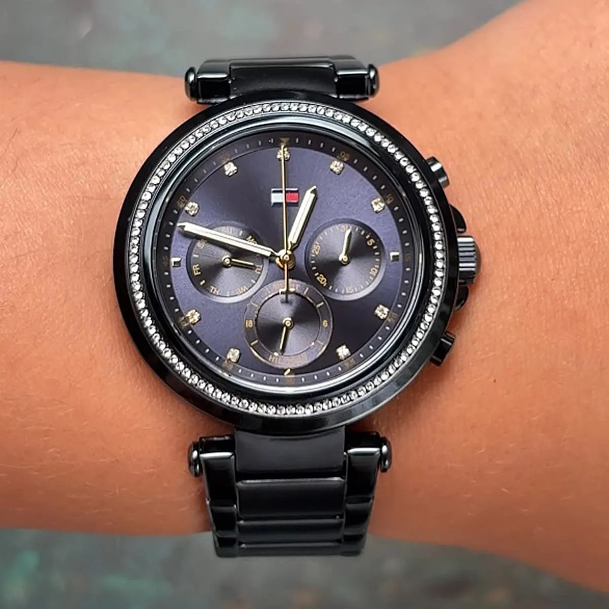 Tommy Hilfiger Emily watch worn on wrist showing navy dial and crystal-set bezel detail