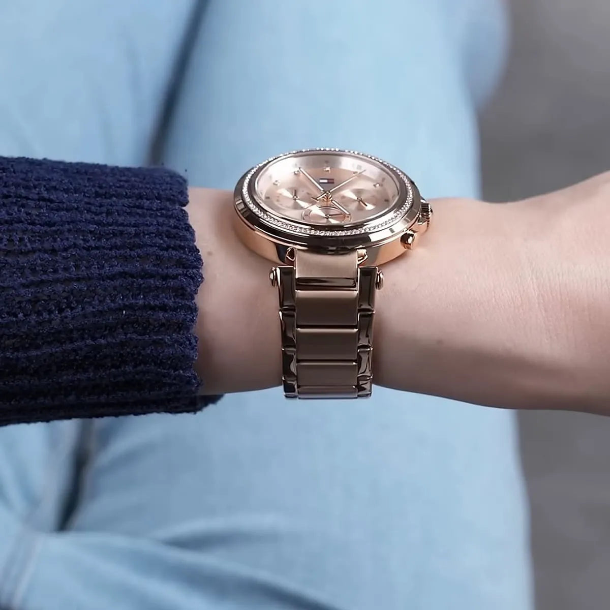 Tommy Hilfiger rose gold watch on wrist showing champagne dial and metal bracelet