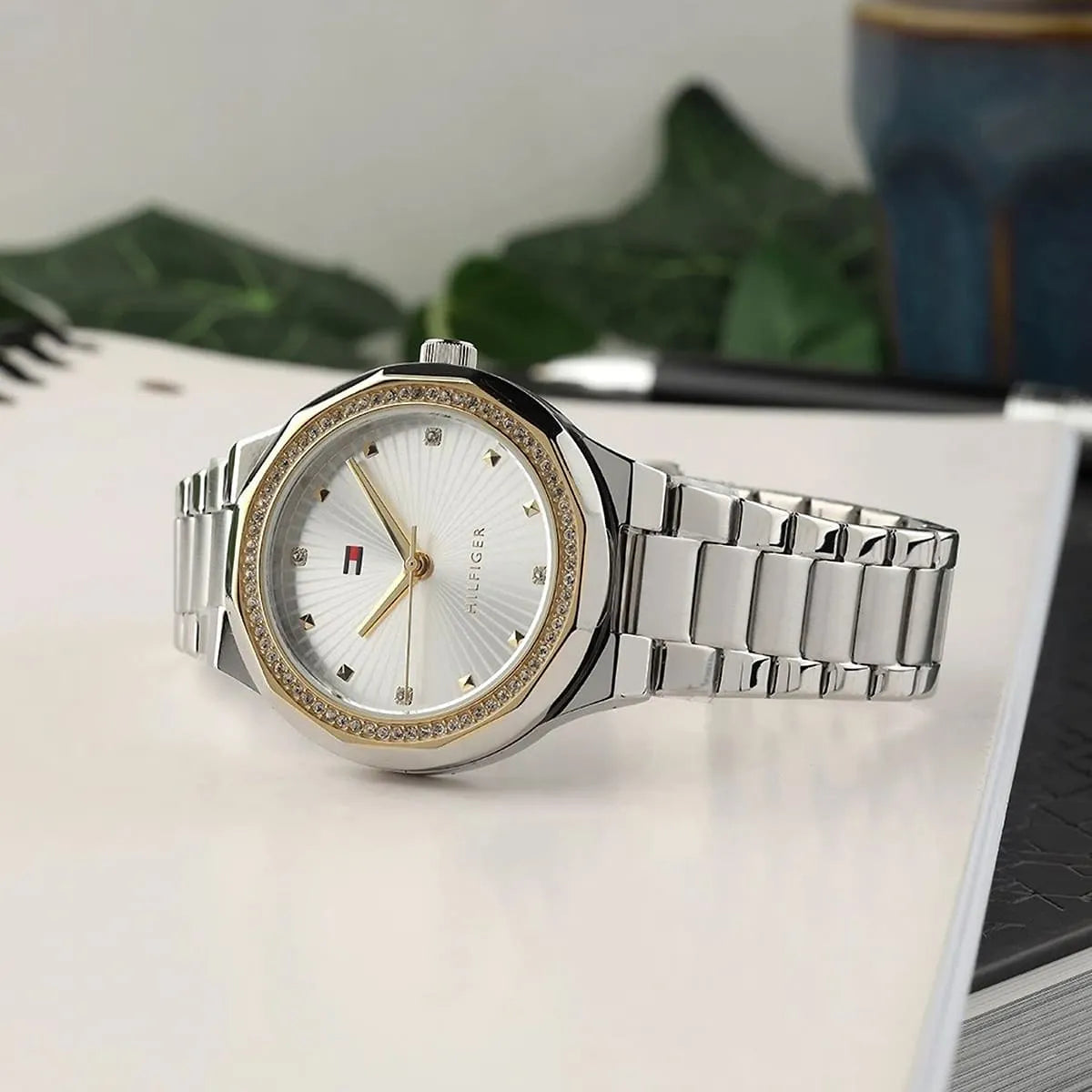 Tommy Hilfiger women's watch displayed on desk with silver stainless steel strap and crystal-set bezel