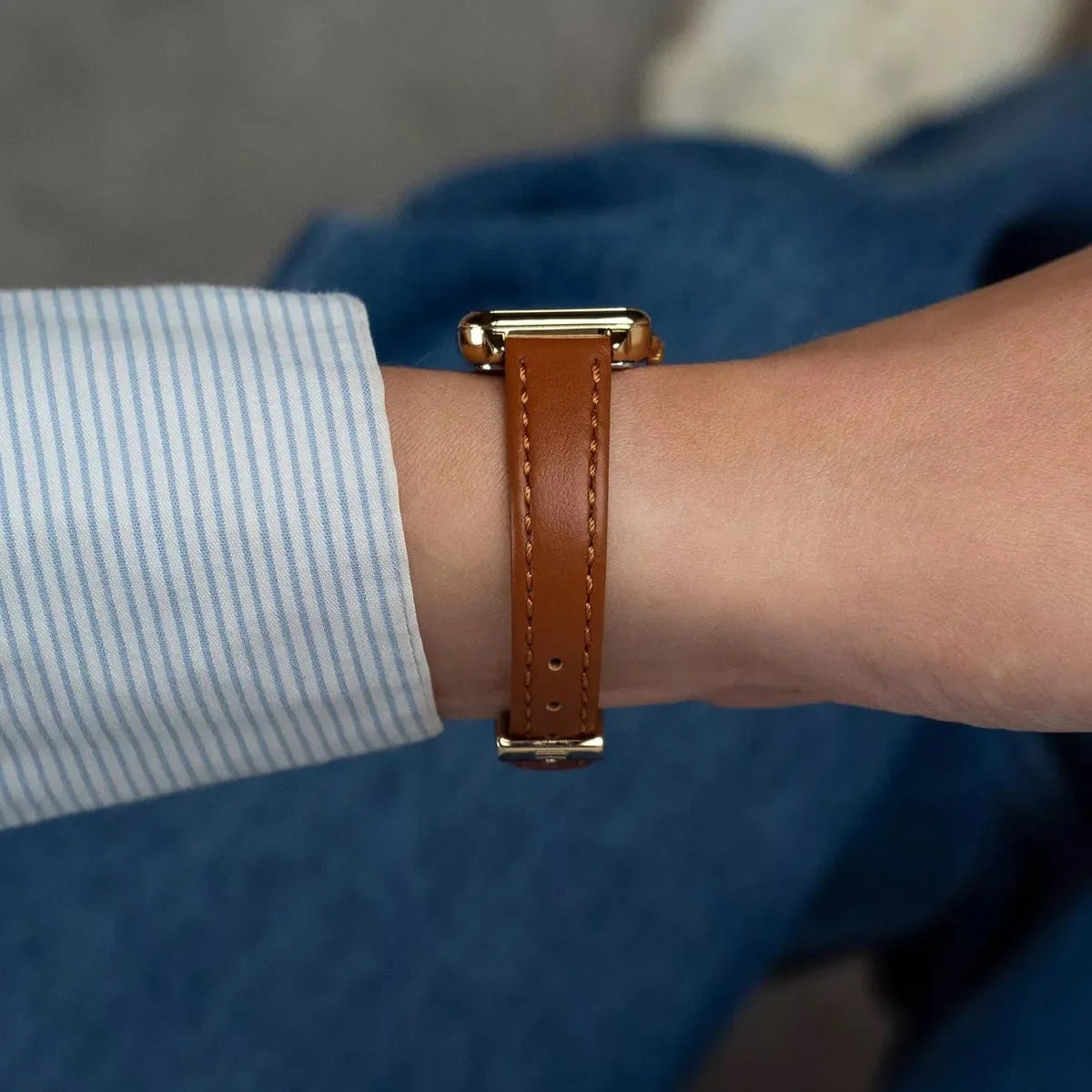 Tommy Hilfiger Mia watch on wrist showing side view of gold case and brown strap