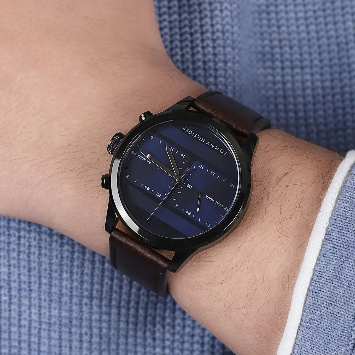 Tommy Hilfiger dual-time watch on wrist showing blue dial and brown leather strap