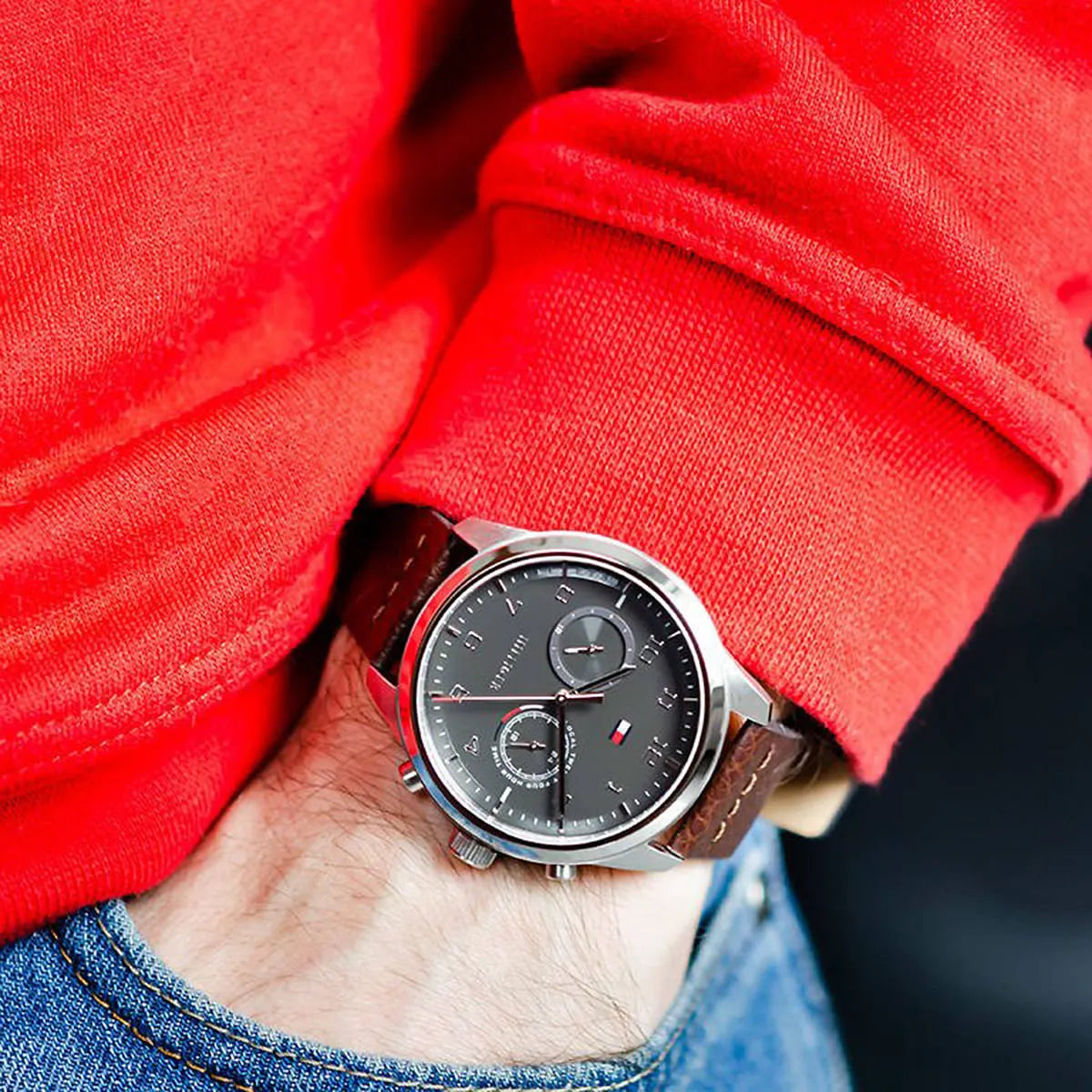 Tommy Hilfiger Patrick watch on wrist with grey dual-time dial and brown leather strap