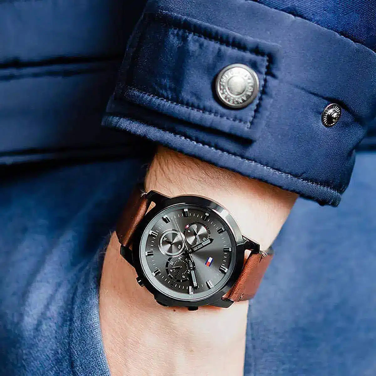 Tommy Hilfiger 1791799 chronograph watch worn on wrist with blue jacket