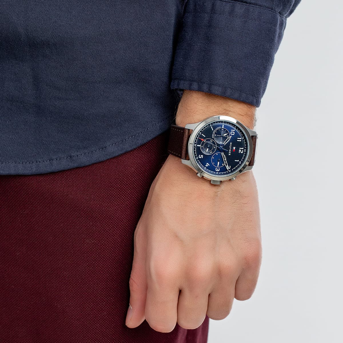 Tommy Hilfiger ASHER chronograph watch on wrist displaying navy blue dial and steel case