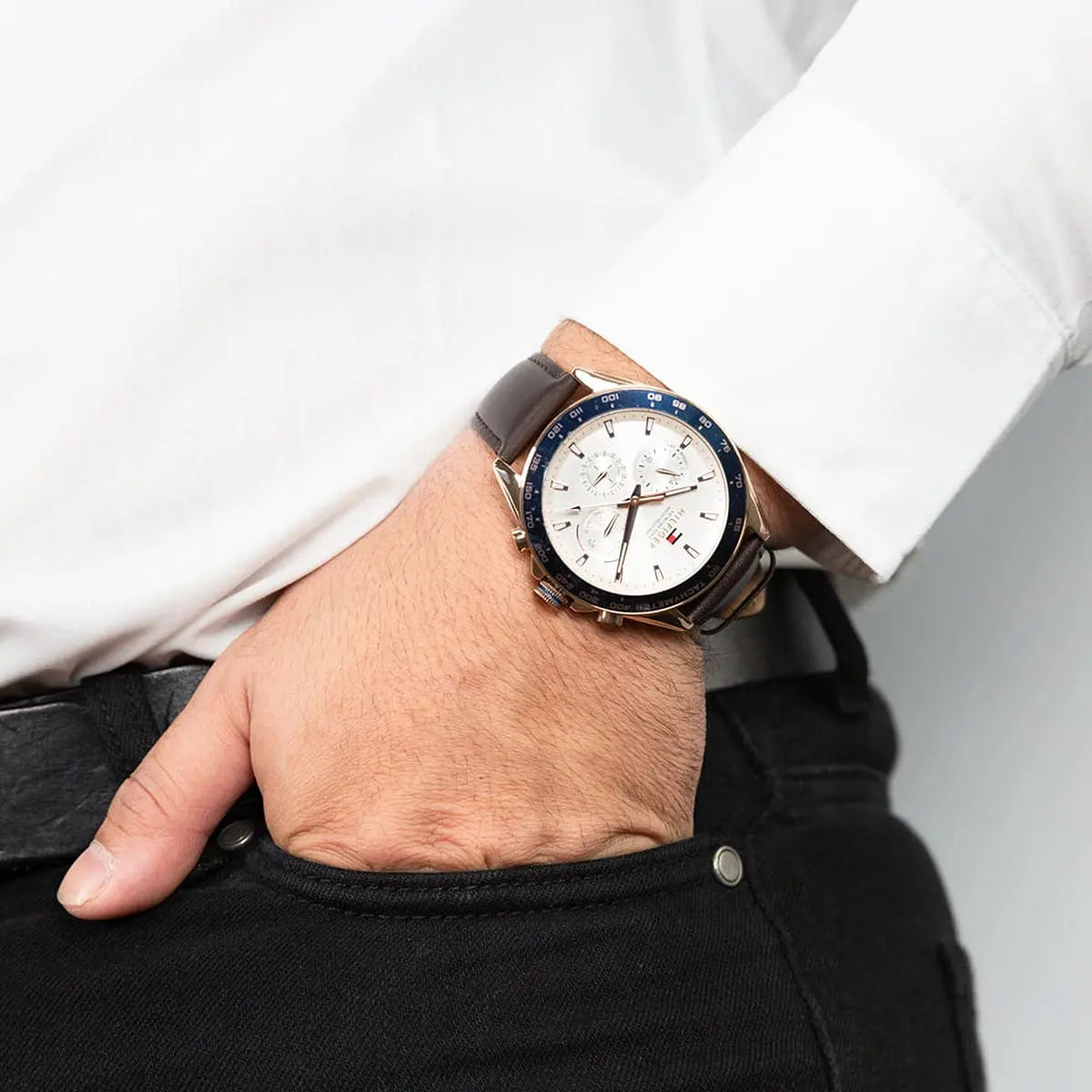 Tommy Hilfiger 1791966 watch on wrist showing white dial and navy tachymeter bezel detail