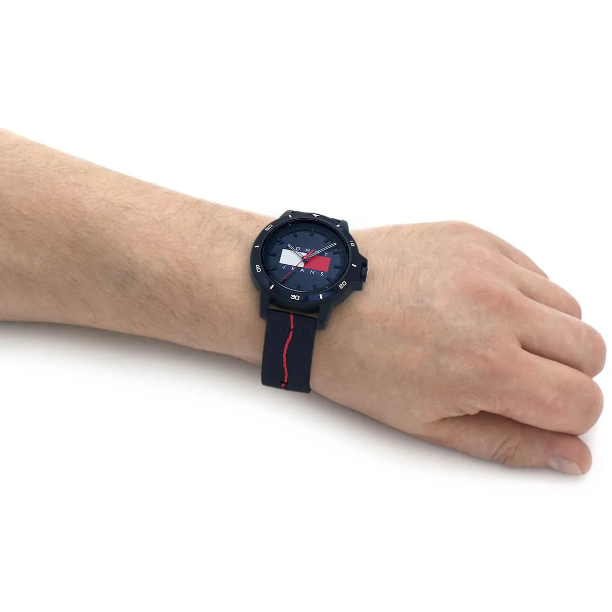 Tommy Hilfiger navy watch with red striped fabric strap worn on wrist
