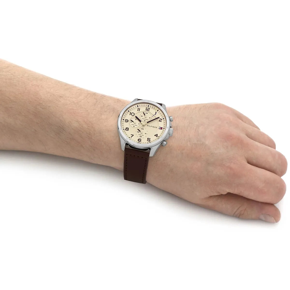 Tommy Hilfiger Axel watch worn on wrist with cream dial and brown leather strap
