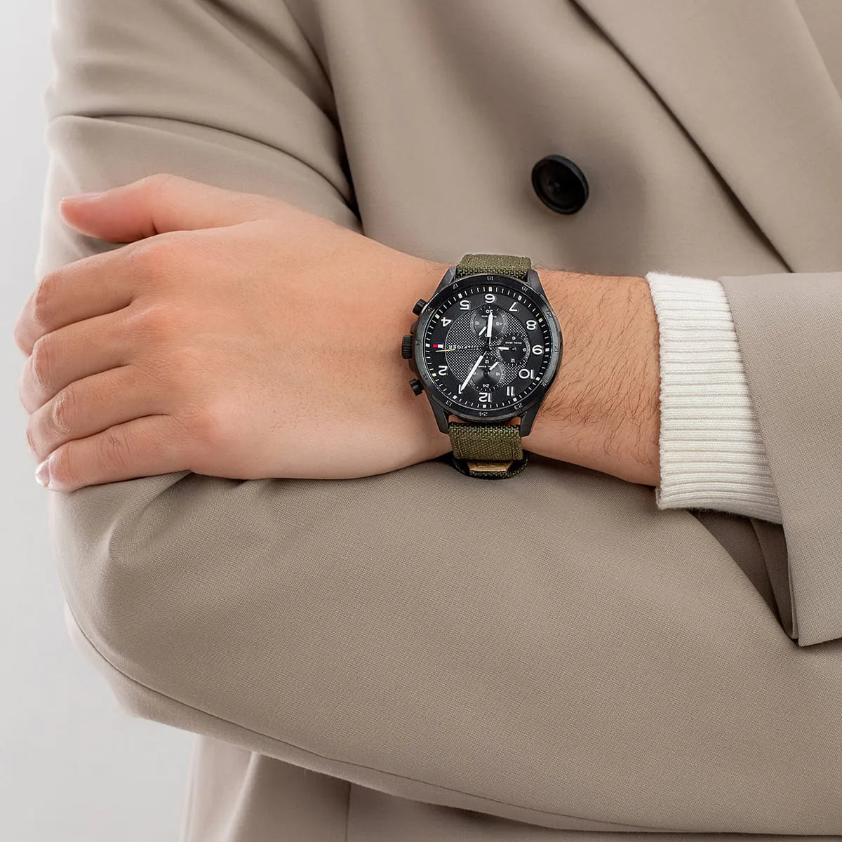 Tommy Hilfiger Axel chronograph watch worn on wrist with green strap and black dial chronograph display